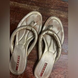 Prada gold flip flops